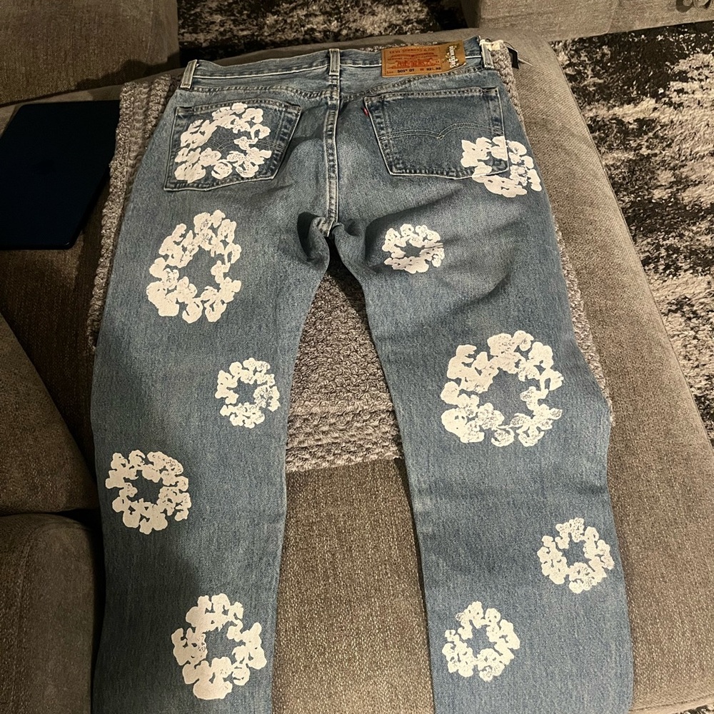 Denim Tears x Levi’s Blue denim jeans with White Floral Patterns